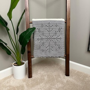 a potted plant sitting next to a wooden chair