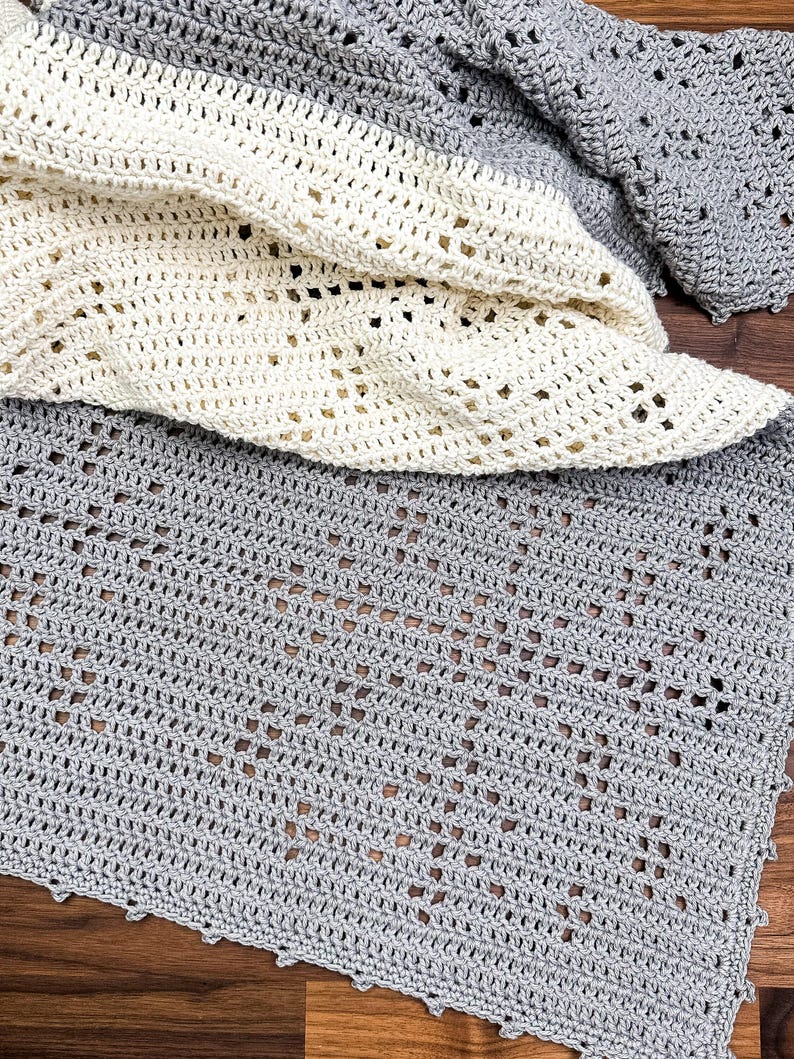 a crocheted blanket laying on top of a wooden floor