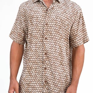 May include: Short-sleeved button-down shirt with a woven basket-like pattern in shades of tan and brown. The shirt has a classic collar and wooden buttons. The fabric appears lightweight and suitable for warm weather.