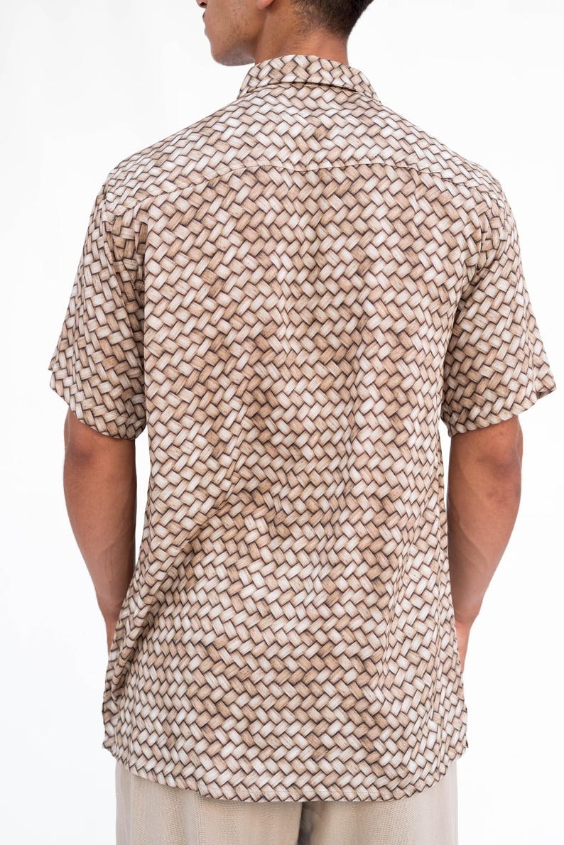 May include: Short-sleeved button-down shirt with a woven basket pattern in shades of tan and cream. The shirt has a classic collar and is made of a lightweight fabric, suitable for warm weather.