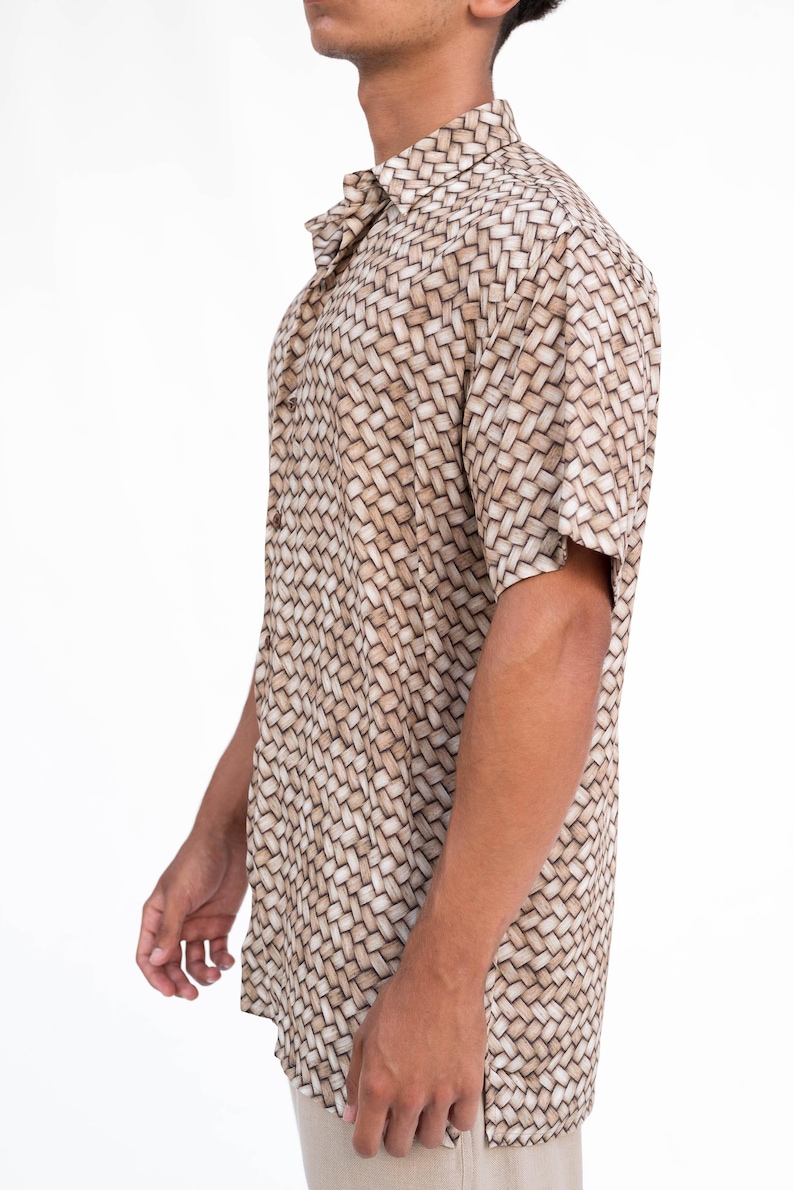 May include: Short-sleeved button-down shirt with a woven basket-like pattern in shades of beige and brown. The shirt has a classic collar and is made of a lightweight fabric, suitable for warm weather. The shirt is a casual wear.