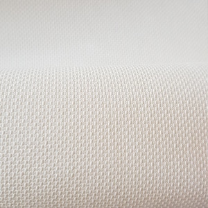 May include: A close-up of a cream-colored fabric with a woven texture. The fabric is folded in half, showing the texture of the weave.