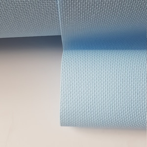 May include: A roll of light blue fabric with a textured weave.