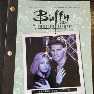 May include: A script book for the TV series "Buffy the Vampire Slayer." The cover features a photo of two actors and the text "Season Two, Vol. 3: The Script Book." The book is bound with a black spine and gold rivets.