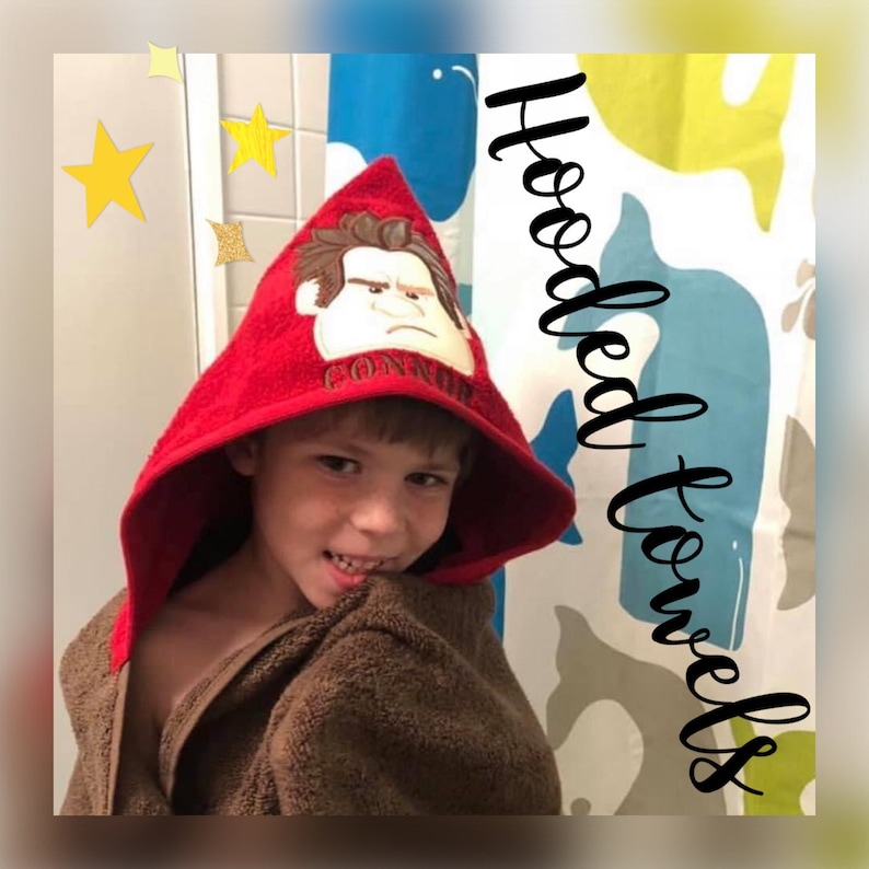 May include: A red hooded towel with a cartoon character embroidered on the hood. The character has brown hair, a red shirt, and a grumpy expression. The towel is being worn by a child. The text "CONNOR" is embroidered below the character.