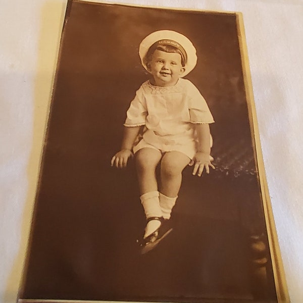 Vintage Black and White Photograph of a Young Child Wearing a U.S. Navy Hat