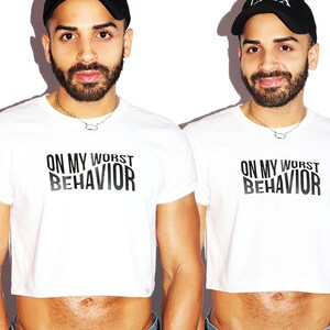 May include: White cropped t-shirt with black text that reads "On My Worst Behavior".