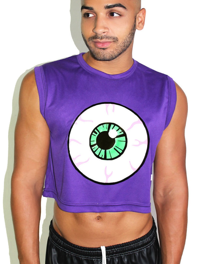 May include: Purple sleeveless crop top with a white eye graphic with a green iris and black pupil.