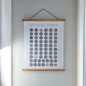 May include: A poster with the title "National Parks" printed on it. The poster features a grid of 64 circles, each containing a black and white illustration of a different national park in the United States. The circles are arranged in 8 rows of 8 circles each.