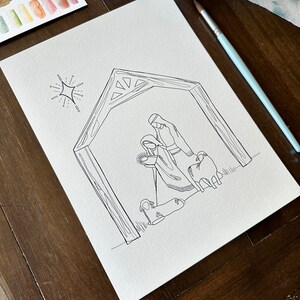 May include: A black and white line drawing of a nativity scene with Mary, Joseph, and two sheep. The scene is set in a stable with a star above.