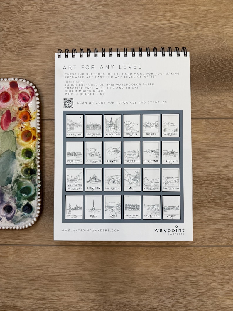 May include: A spiral-bound art pad with the text "ART FOR ANY LEVEL" and illustrations of various locations. The pad includes 24 ink sketches on 9x12 inch watercolor paper, a practice page, and a color mixing chart. A watercolor palette is visible.