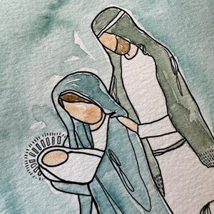 May include: Watercolor painting of the Holy Family. Mary is wearing a blue robe and holding a baby wrapped in white. Joseph is wearing a green robe and a white turban. The baby is surrounded by a halo of light.