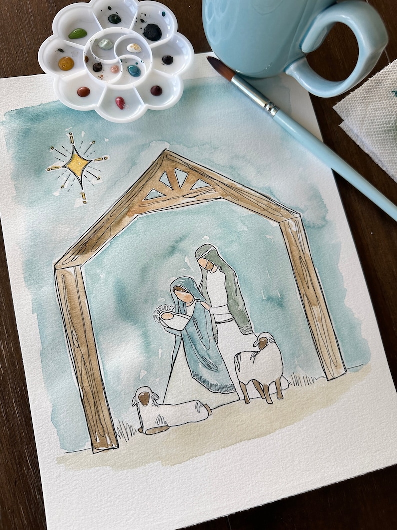 May include: A watercolor painting of the nativity scene with Mary, Joseph, and baby Jesus. The scene is set in a stable with a wooden frame and a star above. There are two white sheep in the foreground.