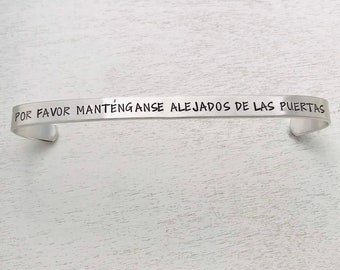 Monorail quote cuff bracelet -  Please stand clear of the doors, in SPANISH -Por favor manténganse alejados de las puertas, Cast Member