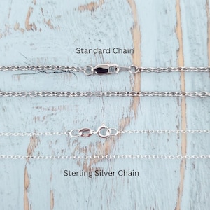 a close up of a chain on a wooden surface