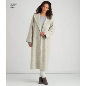 May include: A long, white hooded coat with a speckled pattern. The coat has a shawl collar and a single button closure. The model is wearing the coat with a grey sweater and white trousers.