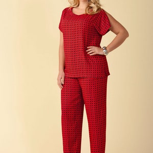 May include: A red and black patterned top and pants set. The top has a scoop neck and short sleeves with a cold shoulder design. The pants are straight leg.