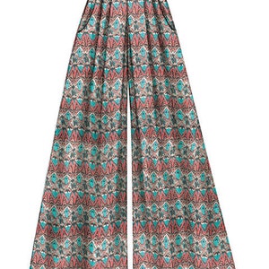 May include: Wide-leg pants with a geometric pattern in shades of pink, blue, and white. The pants have a high waist and a relaxed fit.