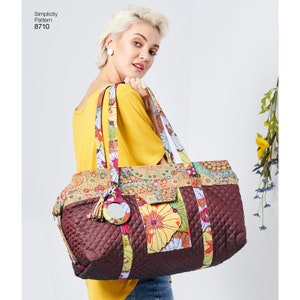 May include: A large, quilted tote bag with a floral print and a brown quilted base. The bag has a zipper closure and a small mirror attached to the front.
