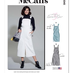 May include: McCall's sewing pattern M8345. The image shows a woman wearing a white overall dress with a front slit, black boots, and a black turtleneck. The pattern includes illustrations of overall buckles and pockets. The text reads "Learn to Sew".