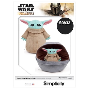 May include: A sewing pattern for a plush Grogu toy and a soft space pram. The pattern is from Simplicity and is for Star Wars: The Mandalorian. The pattern number is S9432.