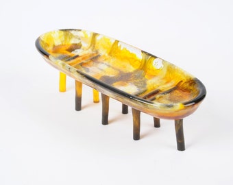Oval dish on 8 slim legs, marbled yellow-brown