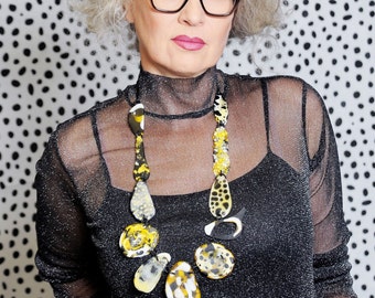 Statement art neckpiece, tortoise shell pattern, with leather loops