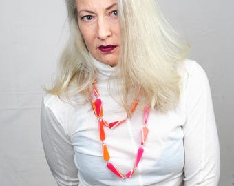 Extra-long necklace made from pink-orange striped elongated resin beads