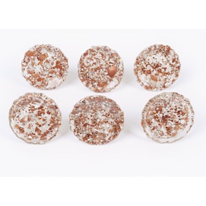 May include: Six round, clear glass knobs with a copper foil design. The knobs have a scalloped edge.