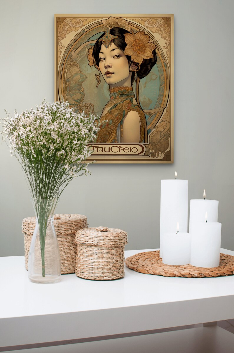 May include: A vintage-style poster featuring a woman with dark hair and a floral headdress. The poster is in a gold frame and has a light blue background. The text "TRUCREIO" is at the bottom of the poster. The poster is hanging on a wall with white candles and wicker baskets on a white table in front of it.