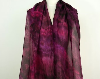 May include: A sheer purple and black tie-dye scarf with a flowing design.