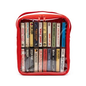 May include: A red rectangular storage case with a clear plastic front panel containing two rows of nineteen assorted music cassette tapes. The tapes feature various artist names and album titles including The Cure, Public Enemy, and Weezer.