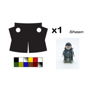 May include: A black and white LEGO minifigure of a man with a green and brown outfit, a gold necklace, and a serious expression. The minifigure is standing on a white background. The text "x1 Sheen" is visible in the image.