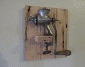 A Vintage Meat Grinder on a rustic recycled pallet wood wall hanging