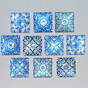 May include: A collection of ten square decorative tiles with intricate blue and white floral patterns. The tiles feature various designs, including symmetrical floral motifs and geometric shapes, on a glossy surface.