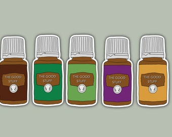 May include: Five essential oil bottles with white lids and labels that say "The Good Stuff". The bottles are brown, green, green, purple, and orange.