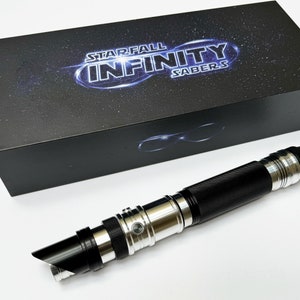May include: A black box with the text "STARFALL INFINITY SABERS" and a lightsaber. The lightsaber has a black handle with silver accents and a black blade. The box is black with a starry design.