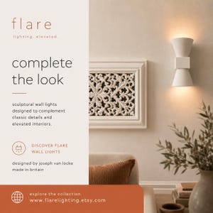 May include: White sculptural wall light with a double cone design, illuminating a warm glow. The image also features a decorative white framed wall art and text that reads "complete the look".