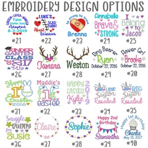 May include: A collection of embroidery design options with various text and graphic elements. Designs include names, dates, and phrases like "Happy 1st Birthday" and "Brave & Strong." The designs are in different fonts and colors, suitable for personalized items.
