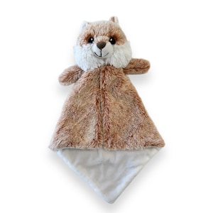 May include: A brown and white fox plush security blanket with a soft, fuzzy texture. The blanket is designed for babies and toddlers.