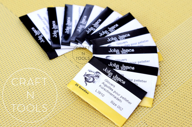 May include: A pack of 25 felting needles, labelled "John James" with a dragon logo. The needles are size 002 and are 3.91 inches long. The packaging is yellow and black with the text "Glovers Aiguilles pour pelletier Kurschnernadeln L3910 Size 002" and "25 Needles".