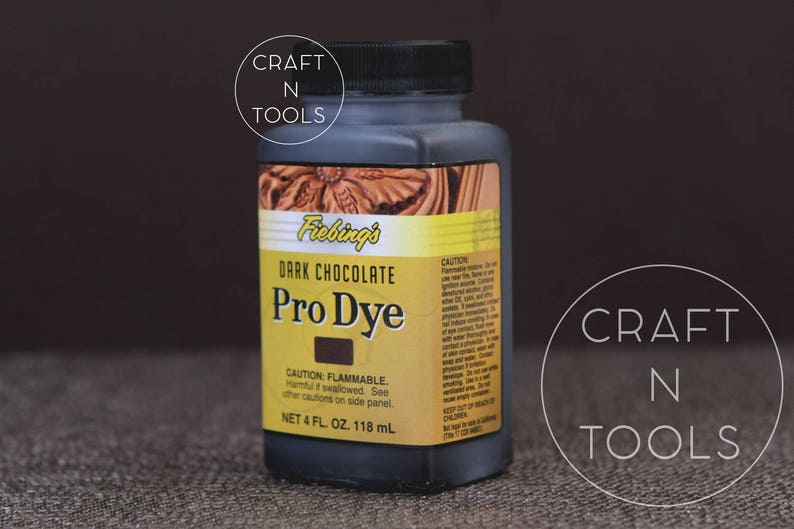 May include: A 4-ounce bottle of Fiebing's Pro Dye in Dark Chocolate. The bottle is labeled with the product name, color, and safety information. It is a leather dye for crafting projects.