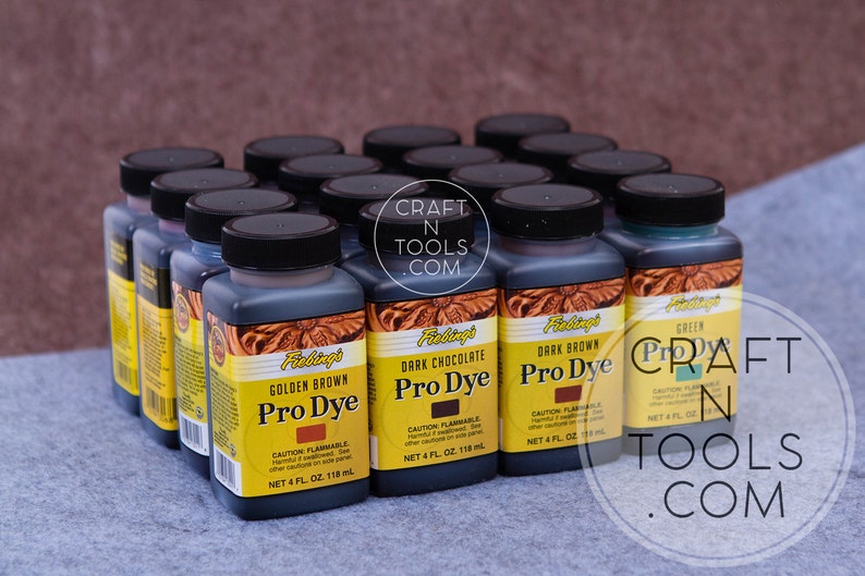 May include: A collection of 12 bottles of Fiebing's Pro Dye leather dye in various colors, including Golden Brown, Dark Chocolate, Dark Brown, and Green. Each bottle contains 4 fluid ounces (118 ml) of dye.