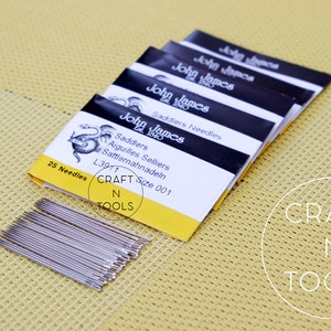 May include: A pack of 25 John James Saddlers needles, size 001, in a yellow and black package with a dragon illustration. The package says "Saddlers Aiguilles Selliers Sattlernahnadeln L3911 Size 001".