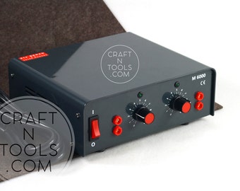 May include: A gray electrical device with two knobs and a red switch. The device has a label that reads "CRAFT N TOOLS .COM" and "M 6000 CE".