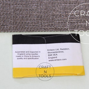May include: A yellow and black packaging label with the text "CRAFT N TOOLS" and information about the product's assembly and manufacturer, Entaco Ltd. The label reads "Assembled and inspected in England using needles made in China to Entaco's quality and specification" and "Entaco Ltd. Redditch, Worcestershire, B98 OEA England www.entaco.com".