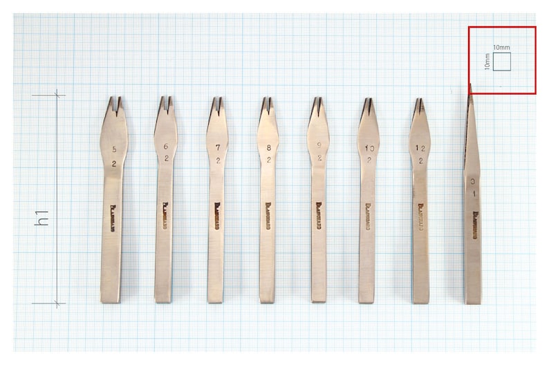 May include: Eight metal tools with different sized prongs, labeled with numbers 5, 6, 7, 8, 9, 10, 11, and 12. The tools are arranged in a row on a gridded surface. A square with the text "10mm" is in the upper right corner of the image.