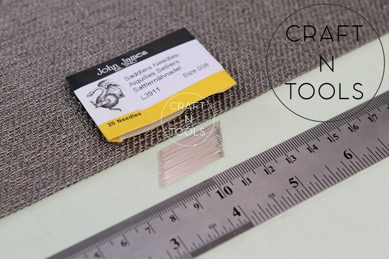 May include: A pack of 25 John James Saddlers Needles, size 008, with a dragon logo and the text "L3911" on the front. The needles are laid out next to a ruler, measuring 6 inches.