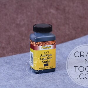 May include: A 4-ounce bottle of black antique leather stain by Fablings. The bottle has a black cap and a yellow label with the product name and size.