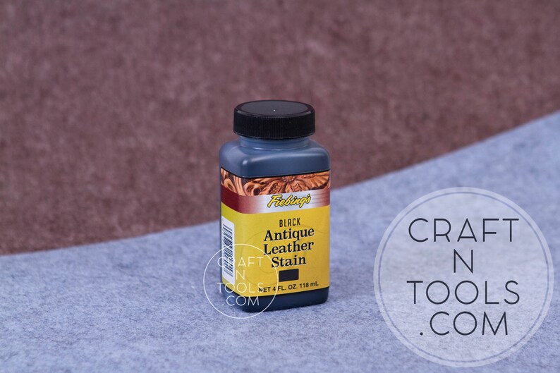 May include: A 4-ounce bottle of black antique leather stain by Fablings. The bottle has a black cap and a yellow label with the product name and size.